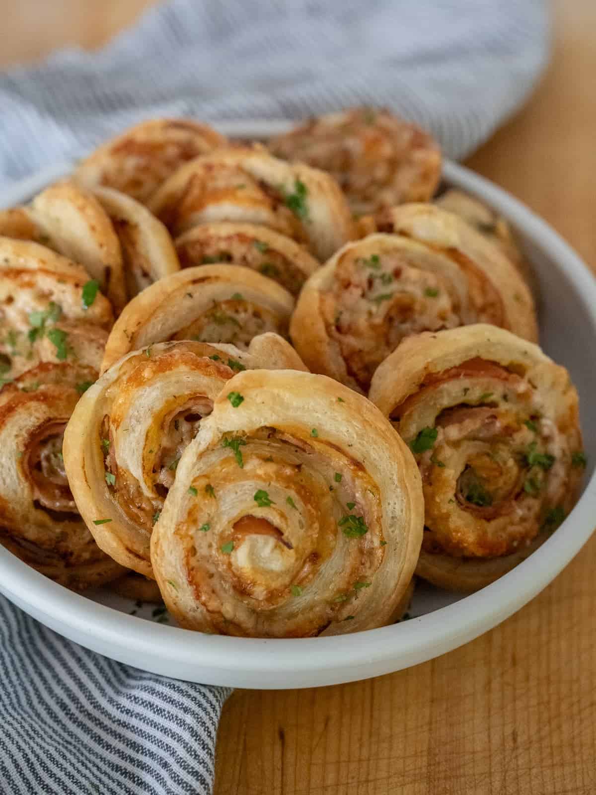 ham and cheese pinwheels in a bowl ready to dive in