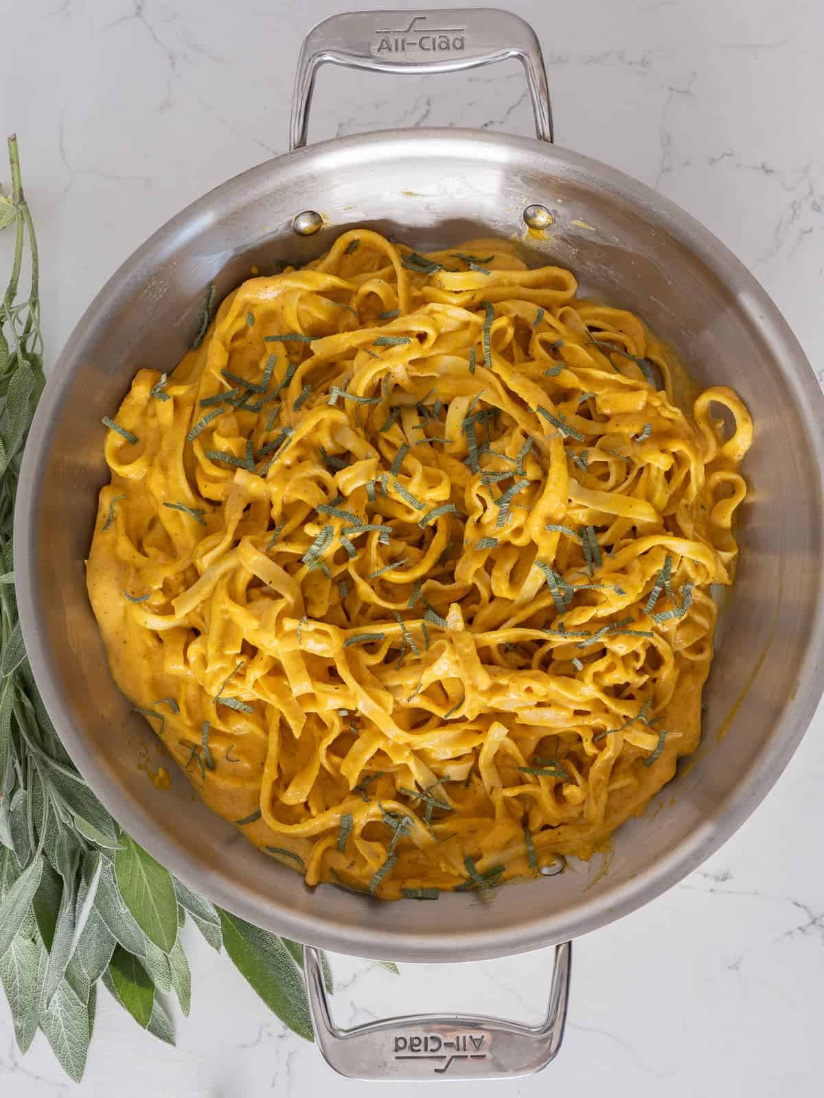 skillet filled with creamy pumpkin pasta sauce