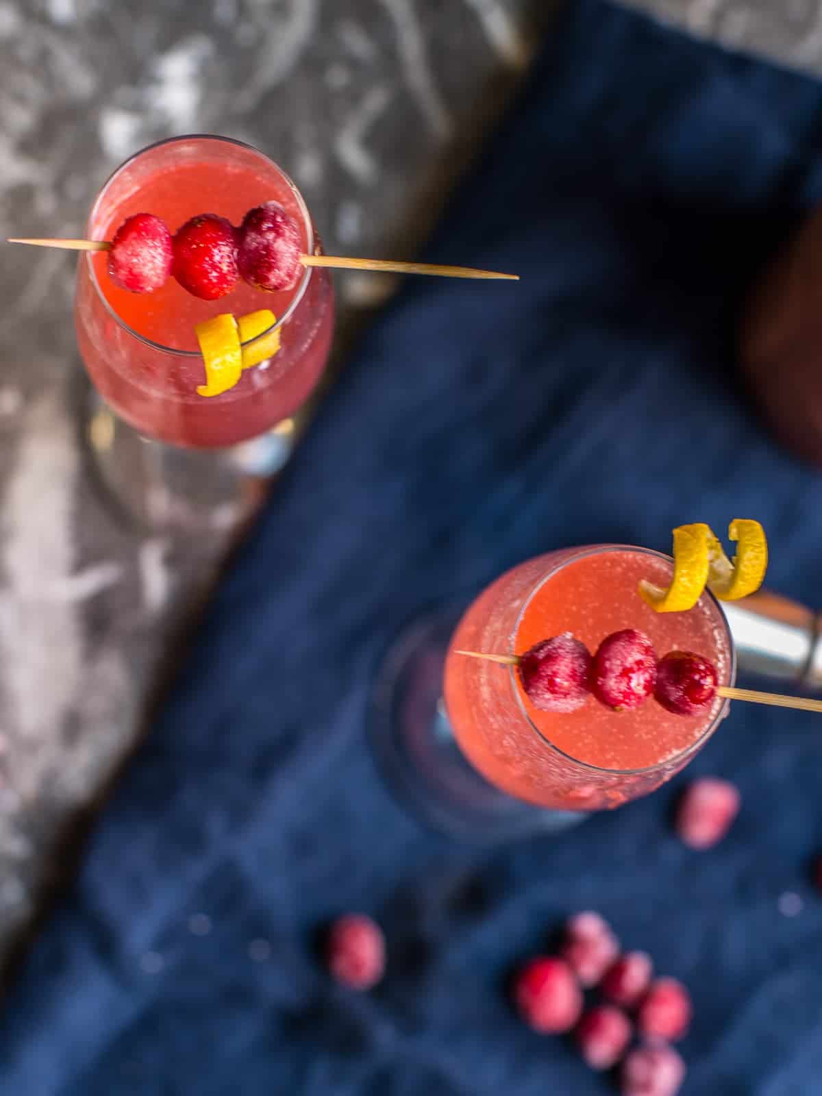 garnish for a cranberry holiday cocktail, sugared cranberries and lemon tsits