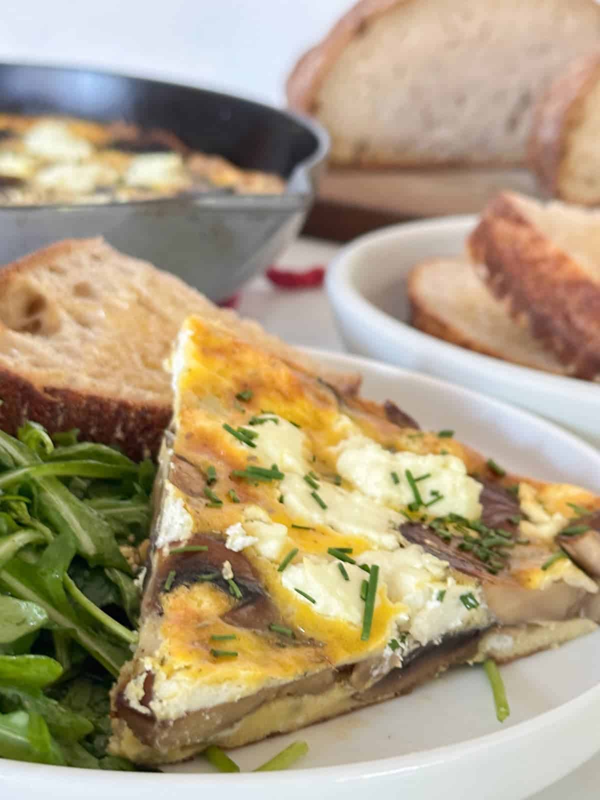 veggie frittata with mushrooms and cheese. served with a salad and toast