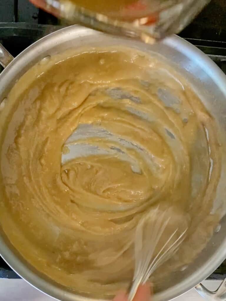 whisk the turkey drippings into the roux until it is completely smooth.