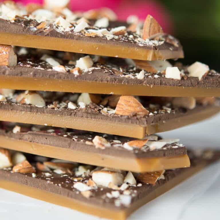a stack of homemade butter toffee with dark chocolate and roasted almonds