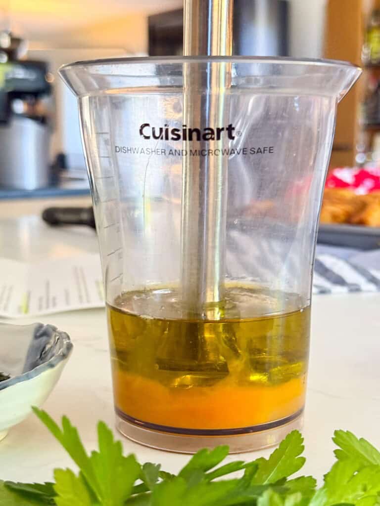 eggs, oil, and lemon juice in a tall jar with an immersion blender