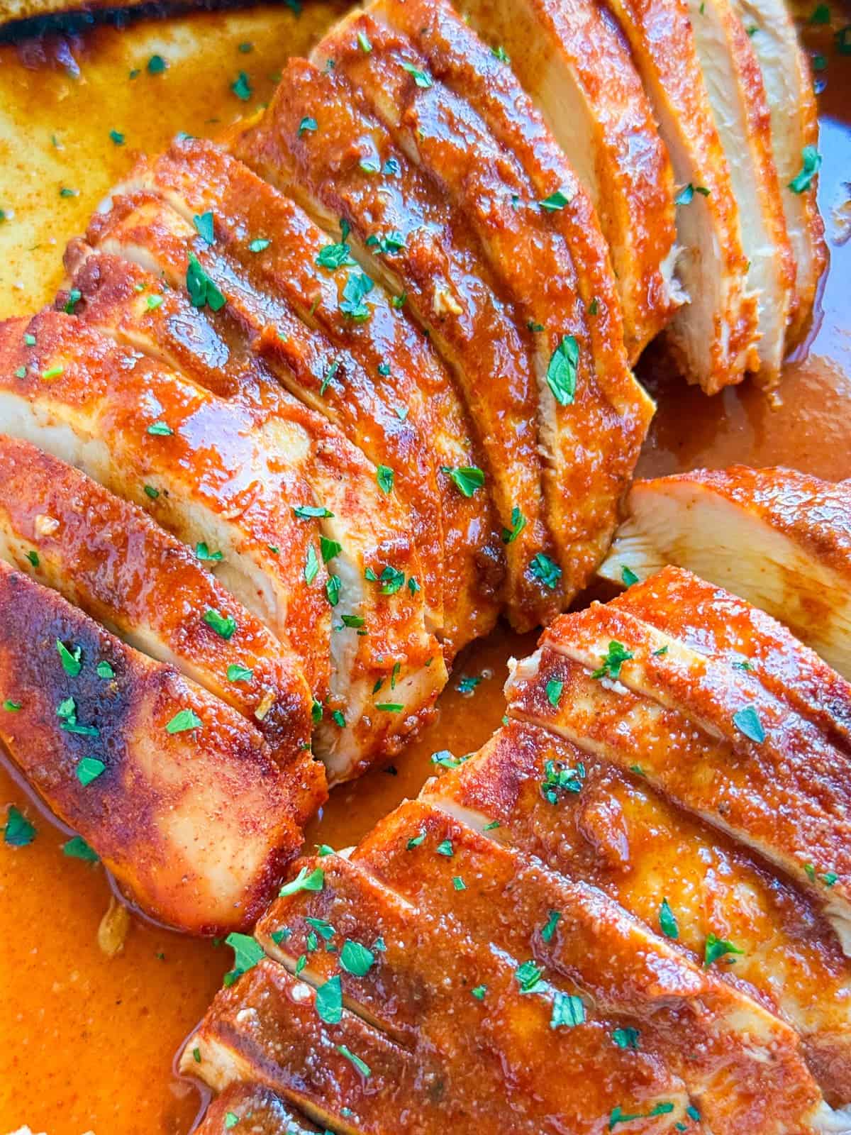 baked buffalo chicken breasts sliced in a pan