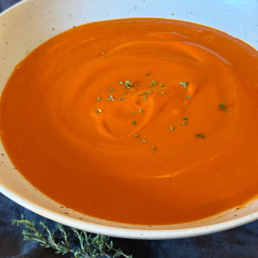 close up shot of bowl of creamy homemade tomato soup
